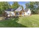 Stylish white farmhouse with attractive landscaping and a welcoming front entrance at 518 Maynard Farm Ln, Stanley, NC 28164