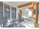 Inviting front porch with rocking chairs and wooden beams, perfect for relaxing at 518 Maynard Farm Ln, Stanley, NC 28164