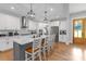 Bright, airy kitchen boasts white cabinetry, stainless steel appliances, granite countertops and a large center island with seating at 518 Maynard Farm Ln, Stanley, NC 28164