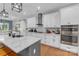 Modern kitchen with white cabinets, stainless steel appliances, and a large island at 518 Maynard Farm Ln, Stanley, NC 28164