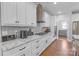 Well-appointed kitchen featuring granite countertops, stainless steel appliances, tiled backsplash, and ample white cabinetry at 518 Maynard Farm Ln, Stanley, NC 28164
