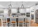 Contemporary kitchen features white cabinets, stainless appliances, granite countertops, pendant lighting, and a sliding barn door entrance at 518 Maynard Farm Ln, Stanley, NC 28164