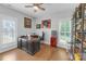 Bright home office featuring large windows, custom desk, and built-in shelves at 518 Maynard Farm Ln, Stanley, NC 28164