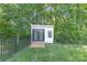 Charming outdoor shed with black trim, a small window box, and a fenced-in yard at 518 Maynard Farm Ln, Stanley, NC 28164