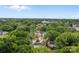 Aerial view of a property surrounded by lush trees, offering privacy and a serene environment at 522 Herms Ave, Mount Holly, NC 28120