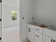 Bright bathroom with white cabinets, modern black hardware, and a view to the outside at 522 Herms Ave, Mount Holly, NC 28120