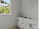 Bright bathroom with white cabinets, modern black hardware, and a view to the outside at 522 Herms Ave, Mount Holly, NC 28120