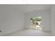 A bright bedroom featuring a large sliding glass door that opens to a view of the backyard at 522 Herms Ave, Mount Holly, NC 28120