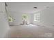 Bright, unfinished room with ample natural light and space, offering potential for customization at 522 Herms Ave, Mount Holly, NC 28120