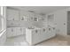 Unfinished kitchen featuring white cabinets and an island ready for personalization at 522 Herms Ave, Mount Holly, NC 28120