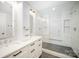 Bathroom featuring double sinks, and a glass-enclosed shower with stunning tile work at 5421 Princess St, Charlotte, NC 28269