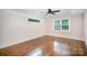 Bedroom with hardwood floors, modern white shiplap accent wall, recessed lighting, and natural light at 5421 Princess St, Charlotte, NC 28269