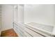 A walk-in closet with custom white shelving and drawer systems at 5421 Princess St, Charlotte, NC 28269