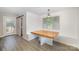 Bright dining area features a wood table with built-in bench seating and a sliding door to the deck at 5421 Princess St, Charlotte, NC 28269