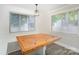 The dining room features a rustic table with built-in bench seating and plenty of natural light at 5421 Princess St, Charlotte, NC 28269