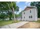 Gray home with mature trees, gray siding, and a well-maintained lawn at 5421 Princess St, Charlotte, NC 28269