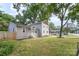 Landscaped property featuring mature trees, gray siding, and a well-maintained lawn at 5421 Princess St, Charlotte, NC 28269