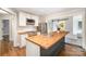 Modern kitchen with stainless appliances, white cabinetry, and butcher block island at 5421 Princess St, Charlotte, NC 28269