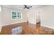 Living room features hardwood floors, recessed lighting, and access to a bathroom with an updated shower at 5421 Princess St, Charlotte, NC 28269