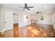 Spacious living room with hardwood floors, ceiling fans, and a view to a staircase at 5421 Princess St, Charlotte, NC 28269