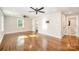 Spacious living room with hardwood floors, ceiling fans, and a view into the bathroom at 5421 Princess St, Charlotte, NC 28269