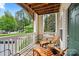 Relaxing balcony with seating, offering a view of lush greenery and a neighborhood street at 5730 Closeburn Rd # H, Charlotte, NC 28210