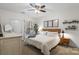 Bright bedroom with a ceiling fan, neutral tones, and a comfortable queen-sized bed at 5730 Closeburn Rd # H, Charlotte, NC 28210