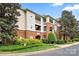 Low angle view of an apartment complex with a brick facade and well-maintained landscaping at 5730 Closeburn Rd # H, Charlotte, NC 28210