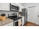 Well-lit kitchen featuring granite countertops, stainless steel appliances, and white cabinetry at 5730 Closeburn Rd # H, Charlotte, NC 28210