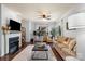 Open-concept living room with a fireplace, cozy seating, and a large window for plenty of natural light at 5730 Closeburn Rd # H, Charlotte, NC 28210