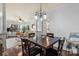Open floor plan connecting dining area and living room, featuring a ceiling fan and hardwood floors at 5730 Closeburn Rd # H, Charlotte, NC 28210