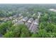 Aerial view of townhome community nestled among lush green trees and landscaping at 5918 Barrowlands Ct, Charlotte, NC 28210