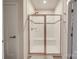 This bathroom features a stand up shower with white tiling and glass doors at 5918 Barrowlands Ct, Charlotte, NC 28210