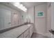 Modern bathroom with granite countertops, white cabinets, and a large mirror at 5918 Barrowlands Ct, Charlotte, NC 28210
