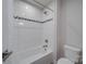 Clean bathroom with white tiled shower and tub, accented with decorative tile at 5918 Barrowlands Ct, Charlotte, NC 28210