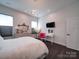 Bright bedroom features wood floors, white walls, and a pink decorative chair at 5918 Barrowlands Ct, Charlotte, NC 28210