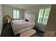 Cozy bedroom featuring neutral colors, wood floors, and bright natural light at 5918 Barrowlands Ct, Charlotte, NC 28210