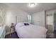 A serene bedroom with a cozy bed, a window with shutters and neutral walls at 5918 Barrowlands Ct, Charlotte, NC 28210