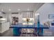 Open dining area featuring stainless appliances, white cabinets, and a blue dining table at 5918 Barrowlands Ct, Charlotte, NC 28210