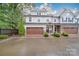 Beautiful townhome showcasing a two-car garage and meticulously maintained front yard at 5918 Barrowlands Ct, Charlotte, NC 28210