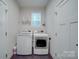 Functional laundry room with a side-by-side washer and dryer and ample storage space at 5918 Barrowlands Ct, Charlotte, NC 28210