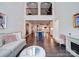 Spacious living room boasting an open layout with hardwood floors, high ceilings, and seamless connection to the dining area at 5918 Barrowlands Ct, Charlotte, NC 28210