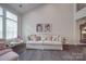 Bright living room with high ceilings, large windows, hardwood floors, and stylish furniture at 5918 Barrowlands Ct, Charlotte, NC 28210
