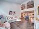 Bright living room featuring hardwood floors, neutral tones, and a clear view of the adjacent dining area and modern kitchen at 5918 Barrowlands Ct, Charlotte, NC 28210