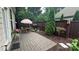 Cozy outdoor patio area with brick pavers, wood fence, and tasteful landscaping for relaxing or entertaining at 5918 Barrowlands Ct, Charlotte, NC 28210
