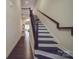 Elegant staircase with wood treads and iron railing leading to the upper level of the home at 5918 Barrowlands Ct, Charlotte, NC 28210