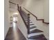Elegant staircase with dark wood treads, rod iron railing, and white risers at 5918 Barrowlands Ct, Charlotte, NC 28210