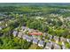 Community aerial view with lush tree coverage, pool, and lake featuring several well-maintained homes at 6424 Chadwell Ct, Fort Mill, SC 29707