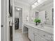 Bright bathroom with white cabinetry, laundry area, and ample counter space at 6424 Chadwell Ct, Fort Mill, SC 29707