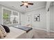 Bright bedroom featuring a ceiling fan, large window and an open doorway to the rest of the house at 6424 Chadwell Ct, Fort Mill, SC 29707